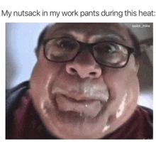 a man wearing glasses is sweating while wearing work pants .