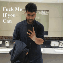 a man taking a picture of himself in a bathroom with the words fuck me if you can