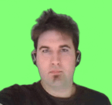 a man wearing headphones is looking at the camera on a green background