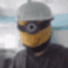 a blurry picture of a man wearing a minion mask and helmet