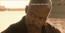 a man is looking at the camera with the words what did you say behind him