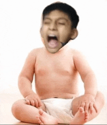 a baby in a diaper is sitting on the floor with his mouth open and yawning .