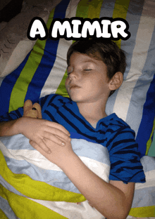 a young boy is sleeping in a bed with a smiley face that says " a mimir "