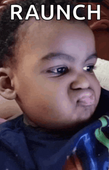 a baby is making a funny face and the words raunch are above him