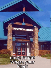 an adoption center with a blue roof and stone pillars