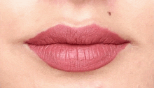 a close up of a woman 's lips with pink lipstick