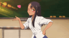 a girl in a white shirt is pointing at a heart on her forehead