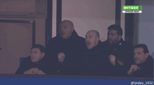 a group of people in a dark room with the number 1 on the top left