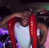 a man is riding a red slingshot ride