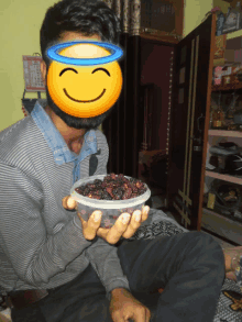 a man with a smiley face on his face holding a bowl of berries