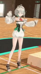 a girl is standing on a trampoline in a gym .