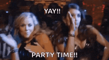 two women are dancing in a club with the words yay party time written on the bottom .