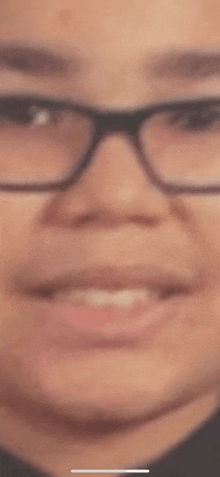 a close up of a person 's face wearing glasses .