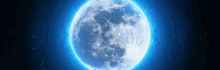 a blue full moon in a dark night sky