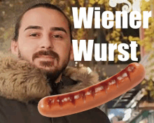 a man holding a wiener wurst in front of his face