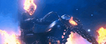 a ghost rider is riding a motorcycle on a fire .