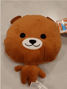 a stuffed teddy bear with a tag that says sno on it