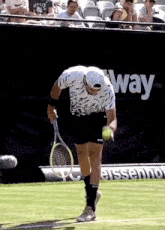 a man is holding a tennis racquet on a tennis court in front of a sign that says " way "