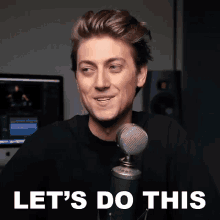 a man standing in front of a microphone with the words let 's do this behind him