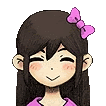 a girl with long hair and a pink bow in her hair is smiling .