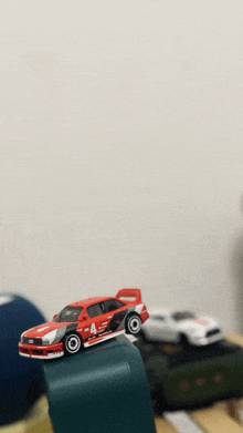 a red toy car has the number 4 on it