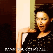 a woman is standing in front of a door and saying `` damn ! you got me all ! ''