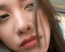 a close up of a woman 's face with red lipstick on her lips