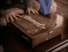 a person is opening a wooden box that says jurassic park on it