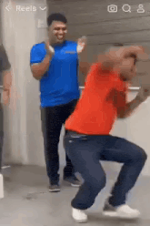 a man in a red shirt is dancing in a room with other men .