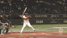 a baseball player swings his bat at a ball in front of a green wall that says world baseball classic