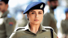 a woman in a military uniform with a blue beret