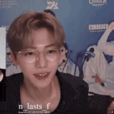 a man wearing glasses and a black shirt says " n lasts f " on the bottom
