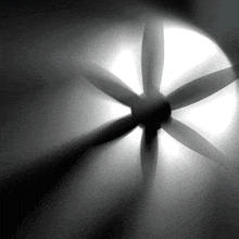 a black and white photo of a propeller spinning