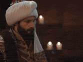 a man with a beard wearing a turban and a scarf that says ' ' ' ' ' on it