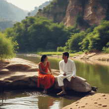 a man and woman sit on a rock by a river