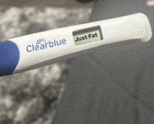 a clearblue pregnancy test with a just fat button on it .