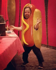 a man dressed as a hot dog with mustard on his face