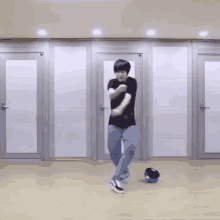 a man is dancing in a room with a ball in the background .