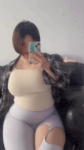 a woman is taking a picture of herself in a mirror
