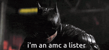 a man in a batman costume is standing in the rain and says i 'm an amc a lister .