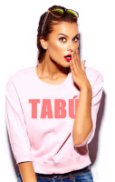 a woman wearing a pink shirt that says tabu covering her mouth