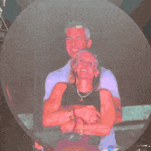 a man in a purple shirt is standing next to a woman in a pink shirt