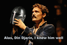 a man with a mustache holds up a helmet with the words alas din djarin i knew him well below him