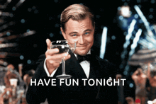 a man in a tuxedo holds up a glass of wine with the words have fun tonight written below him