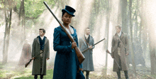 a woman in a top hat is holding a rifle in front of a group of men