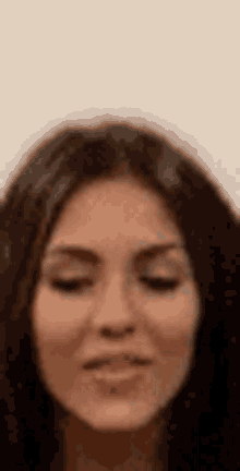 a close up of a woman 's face making a funny face with her eyes closed .