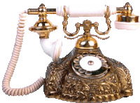 a gold and white telephone with a cord hanging off of it