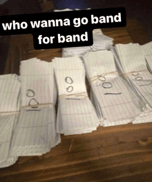 a bunch of papers on a wooden table with the words who wanna go band for band