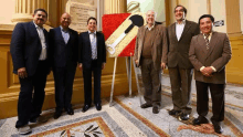 a group of men standing in front of a sign that says " exit "