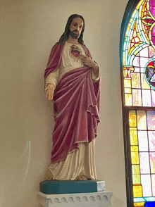 a statue of jesus with a heart in his hand